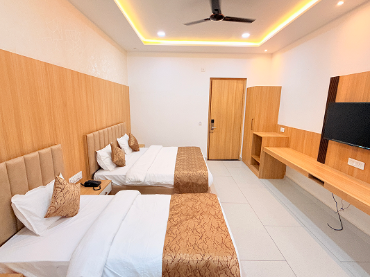 Family triple room at Aaravya Hotel Ayodhya — 1 double + 1 single bed