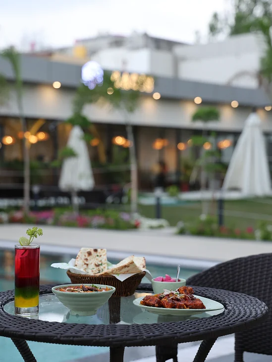 Poolside seating — al fresco, evening lights