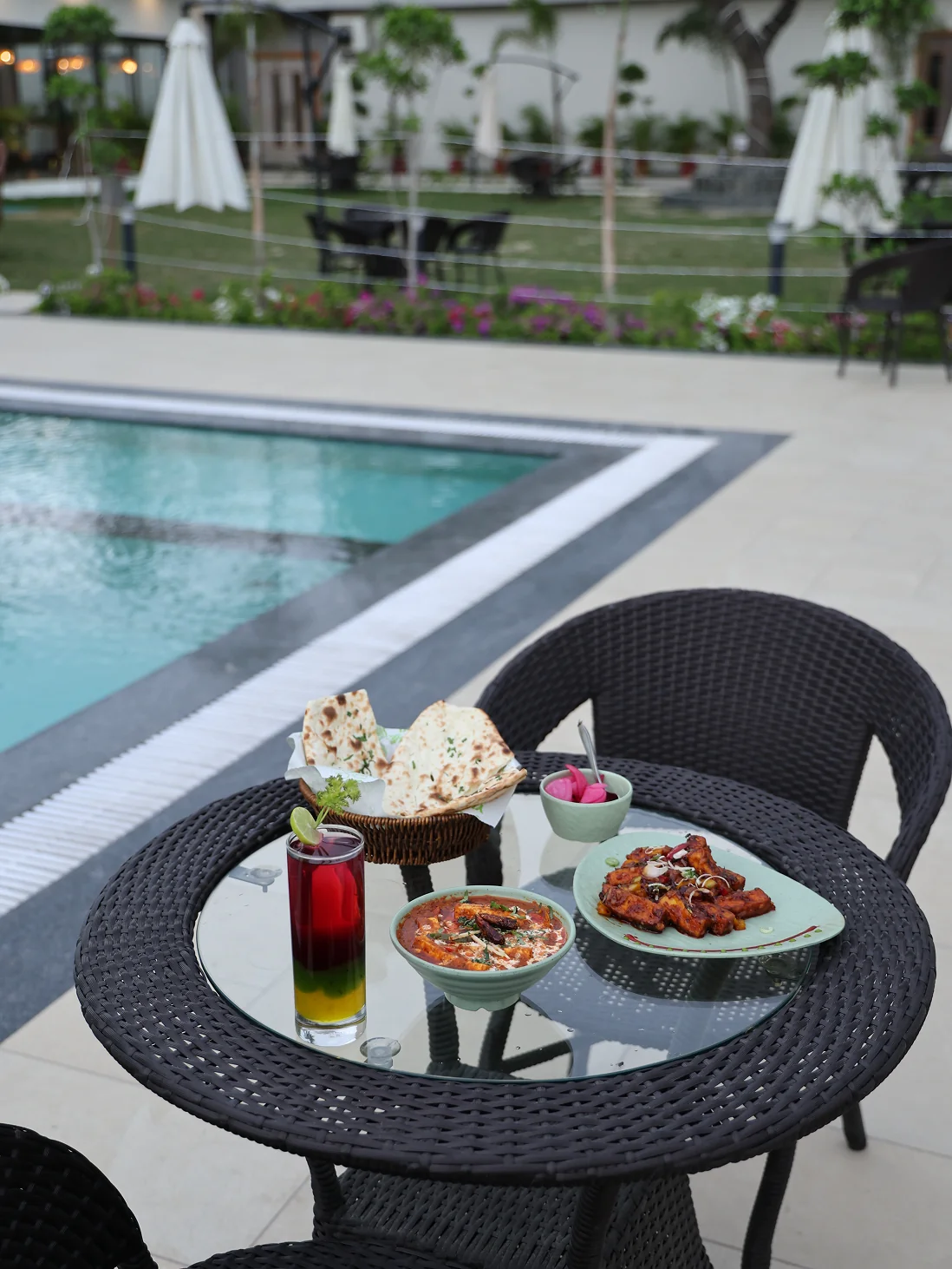 Oasis outdoor poolside seating — evening, ambient light